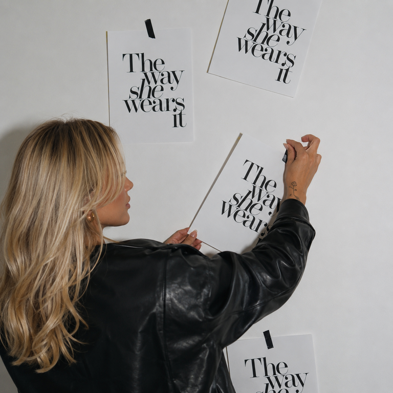 Creator placing campaign posters on a wall